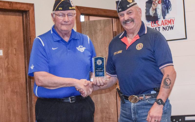 Terry Brokoff is pictured accepting an award from Jim Volant.