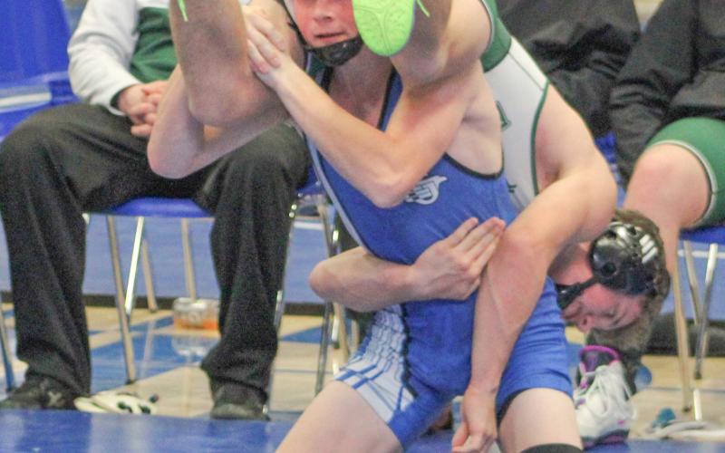 Gladwin’s Ethan Palmateer gives a Pine River opponent a lift during a match at Saturday’s team tournament.