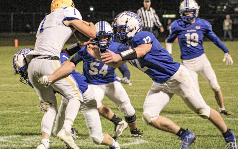 Gladwin’s Mason Cameron, Jaden Tyra and Jeff Zeitz meet at the quarterback for a sack during Friday night’s victory over visiting Harrison.