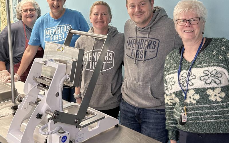 Team members help package meals at Antler Arms Dining Center.