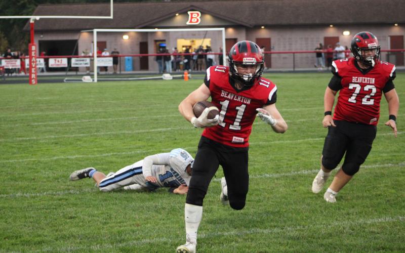 Beaverton’s Caden Snyder breaks a tackle and heads upfield during Friday night’s Homecoming loss to Meridian.