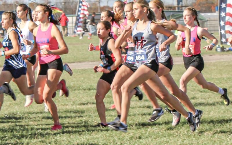 Gladwin seniors Abby Robinson and Lily Binger take off with the masses at the Division 2 state meet at Michigan International Speedway Saturday.