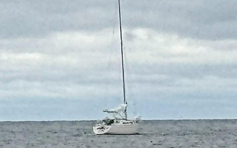 A sailboat remains stranded in Lake Huron, offshore of Point Au Gres, after two boaters from Ann Arbor ran aground and became stranded in rough water Tuesday. Michigan Department of Natural Resources conservation officers were able to safely rescue and return both boaters to shore.