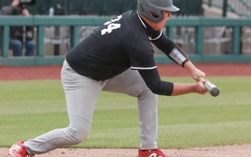 Beaverton’s Ben Zdrojewski tries to get a bunt down at Dow Diamond during Thursday’s sweep of Pinconning. PHOTO BY TERINA BARTA