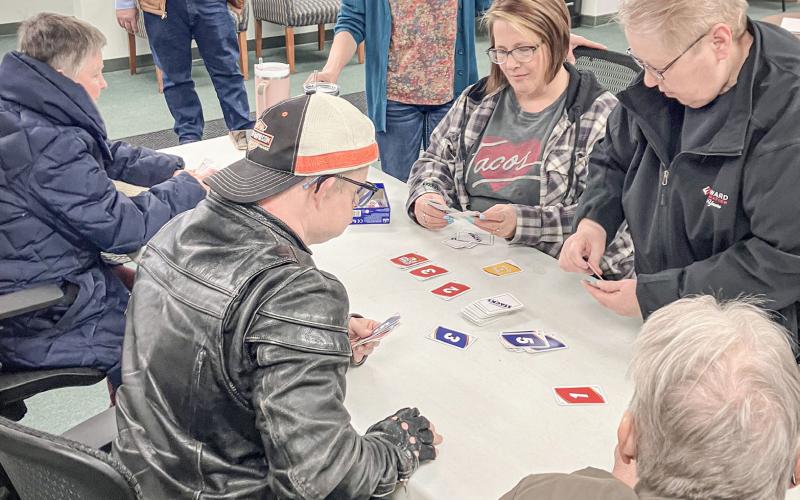Billings Township Supervisor Tim Mester watches a card game that broke out at the Township Hall last Wednesday as part of Community Activity Day.