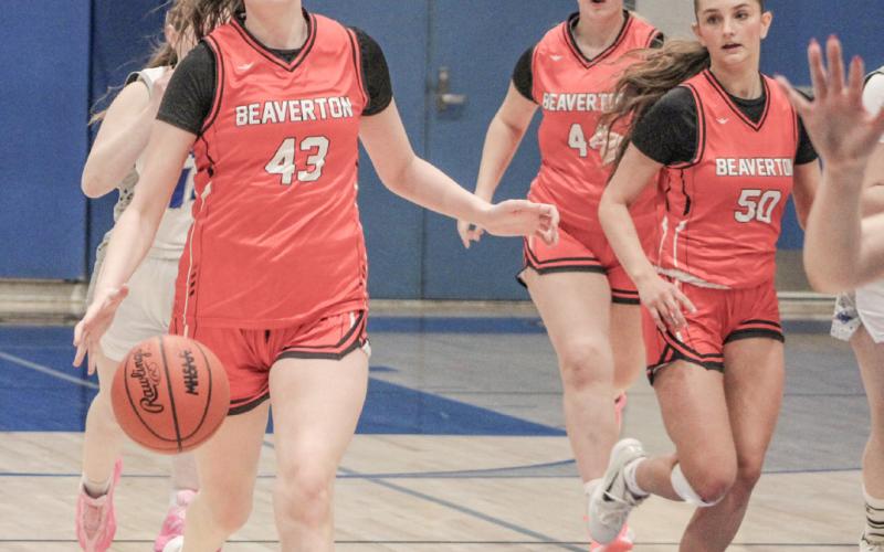 In a bit of role reversal, Beaverton center Taryn Roberts leads the break at Gladwin, trailed by point guard Myah Hubble.