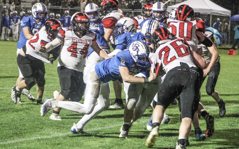 With a wet ball and a rain-soaked field, winning battles like this in the trenches lifted the Gladwin football team to a 50-0 victory over visiting Beaverton Friday night in The Battle For Butch.