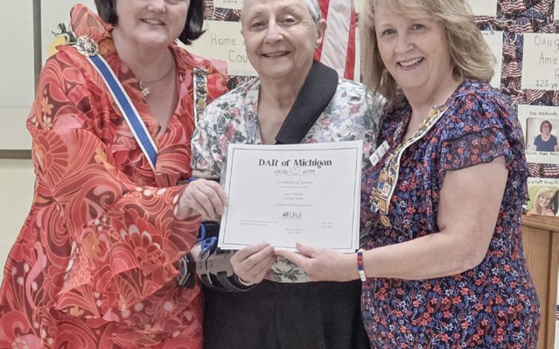 DAR member Janet Adamski is proudly acknowledged with a certificate of 55 years of membership. Pictured from left to right: Dawn Brady, Janet Adamski, and Camille Subject.