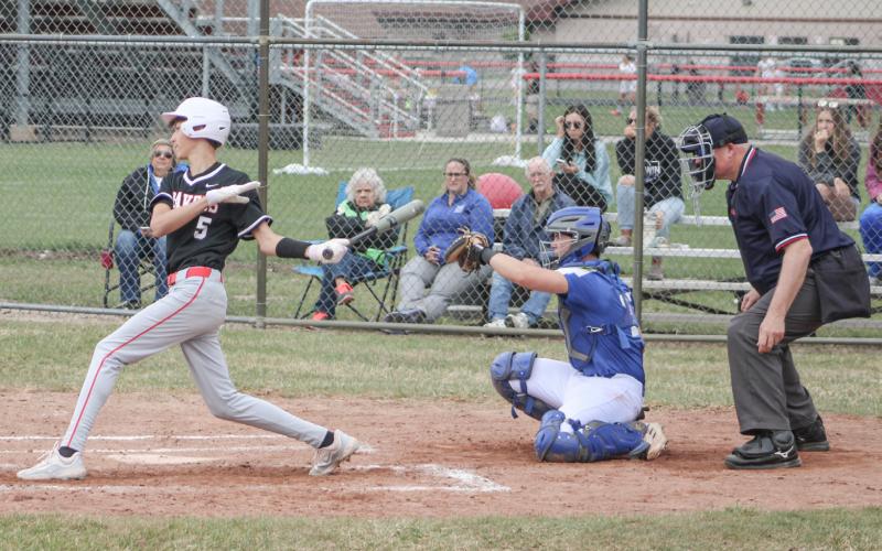 Beaverton’s Jace Mishler hits the ball during the first game of last Tuesday’s doubleheader split with visiting rival Gladwin.