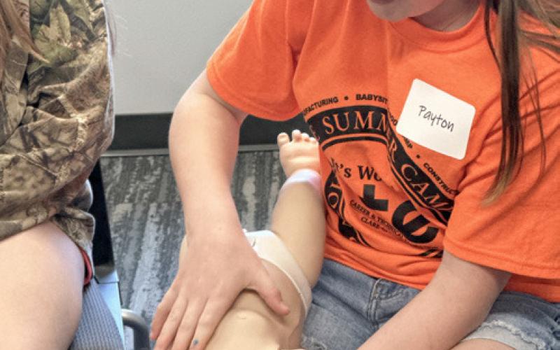 Participants engage in a fun hands-on activity during the Babysitting Bootcamp, part of the CTE Summer Camp, gaining valuable skills for future babysitting opportunities.