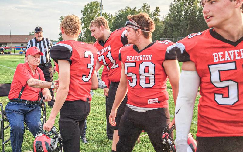 Legendary Beaverton football coach Dick Van Wieren greets members of the 2023 team prior to the first game of the season. Van Wieren passed away last week at age 87. RUSTY GOVITZ, BEAVERTON SCHOOLS