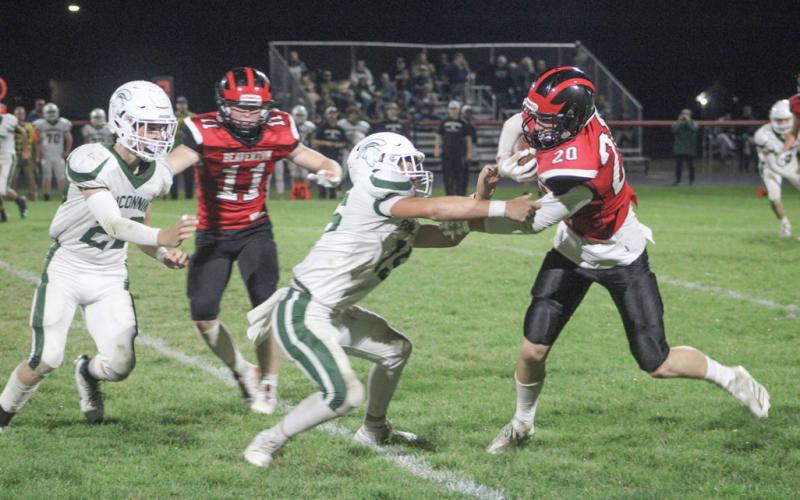 Beaverton’s Ian Roberts wards off a tackler after making a catch during Friday night’s loss to Pinconning.