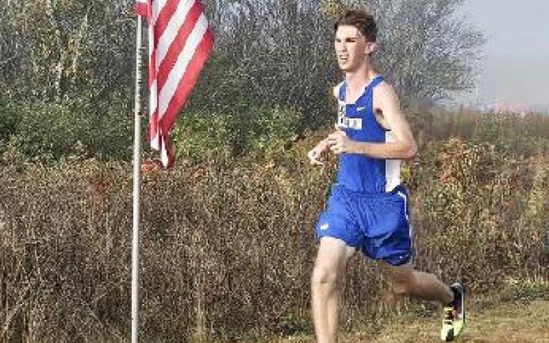Gladwin’s Elijah Christensen ran past Old Glory and his own school record Saturday at the Veterans Serving Veterans Invitational.