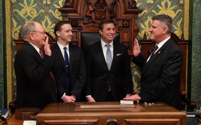State Rep. Mike Hoadley (right), of Au Gres, is sworn in by former House Clerk Gary Randall (far left) on Wednesday, Jan. 11 at the state Capitol. Hoadley was joined by legislative staff members (from left) Ryan Zoschnick and Trevor Pittsley for the ceremony.
