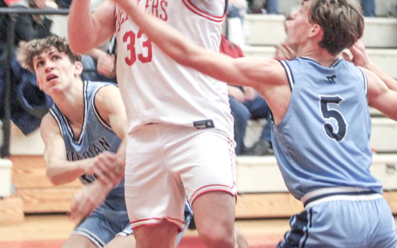 Beaverton’s Landon Love bashes through the swarming Meridian defense on his way to the basket during Friday night’s loss to the visiting Mustangs. BEAVERTON