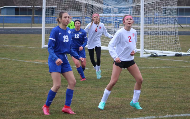 Gladwin’s Lauren Nobach and Beaverton’s Emily Skotynsky eagerly await a throw-in.