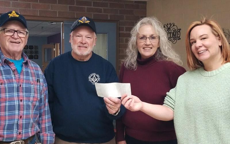 Representatives of the Masonic Lodge passing along their $200 donation to the Gladwin Council on Aging.