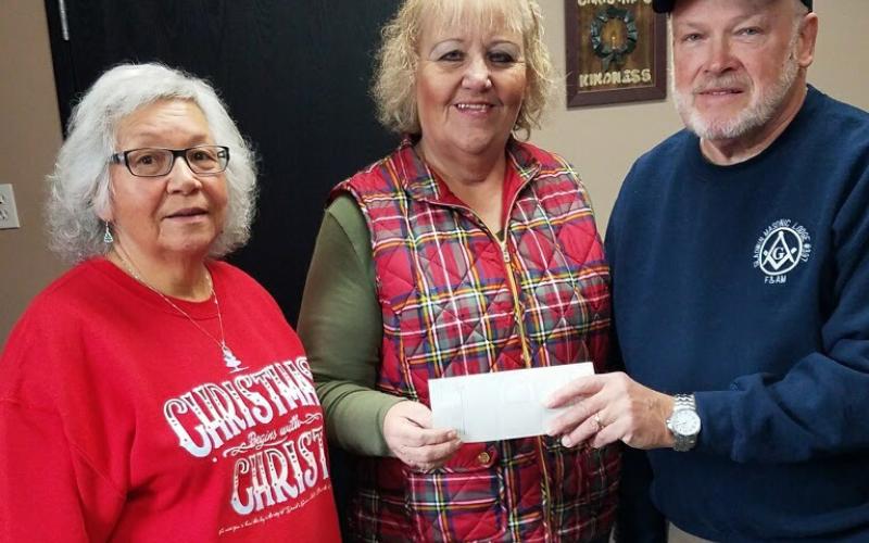 Christmas Kindness staff accepts a $500 donation from the Masonic Lodge.