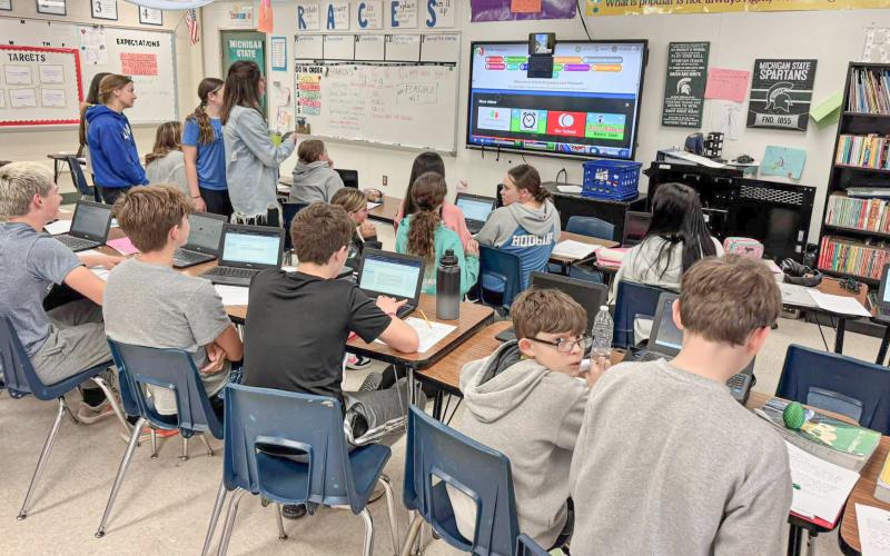 Students and co-workers get a FaceTime update from Gladwin Junior High School eighth grade English teacher Kim Kaleto (inset) live from the Boston Marathon last week.