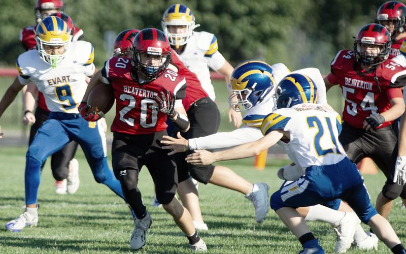 Beaverton’s Remington Brethour tries to elude a pair of would-be Evart tacklers during the Beaverton JV football team’s 0-0 tie Thursday. PHOTO BY JESSICA KELLER