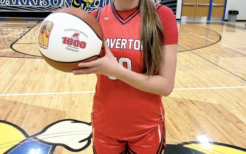 Beaverton junior Myah Hubble shows off the personalized basketball she received Thursday night after passing the milestone for 1,000 career points in a 78-48 victory at Harrison. Needing 17 points pregame to reach the magic number, Hubble finished with a game-high 37.