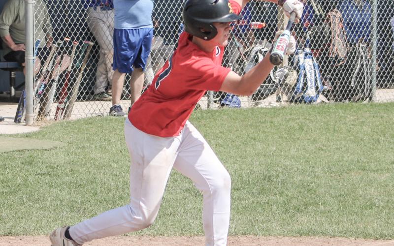 Jackson Fritz of the Gladwin Lightning American Legion Post 171 lays down a bunt during a first-inning rally that led to a 10-0 victory Saturday.