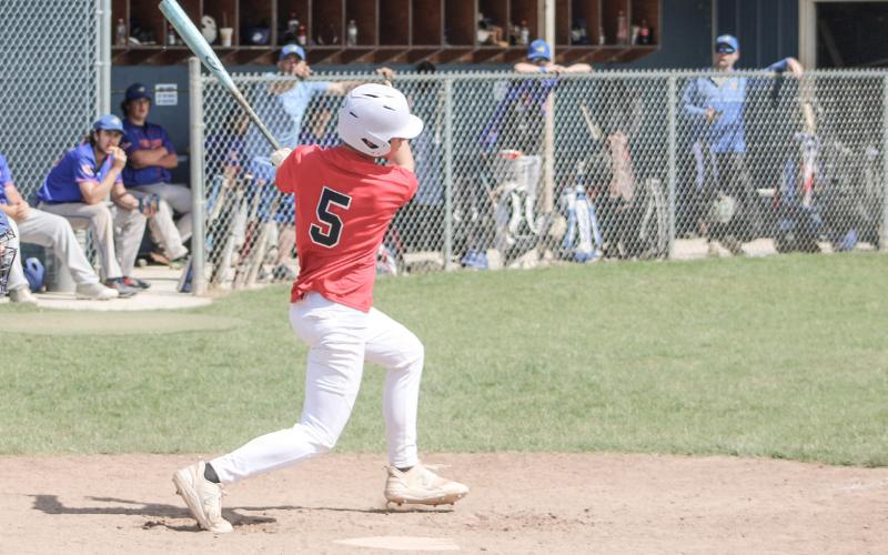 Korbin Harris follows through on a swing as the Gladwin Lightning rallies for a win on Saturday afternoon.