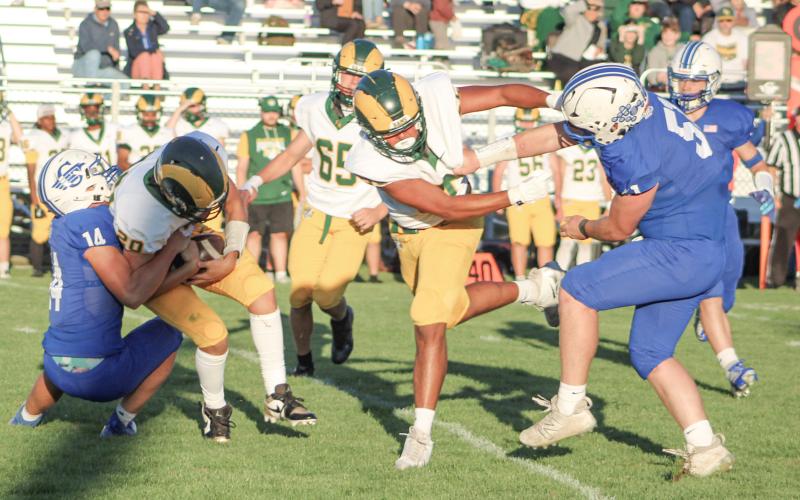 Gladwin’s Preston Willert drags down Flat Rock quarterback Joel Scully for a sack during Thursday night’s loss to the Rams.