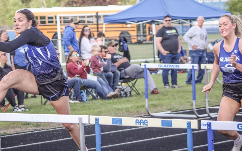 Gladwin’s Ava Gary and Lizzie Haines race to a 1-2 finish in the 100 hurdles during the Legends Track Meet Friday.