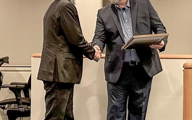 State Rep. Bill G. Schuette (far left) presents a tribute to Officer Steven Pomransky of the Midland Police Department at a Midland City Council meeting on Monday, Dec. 18.