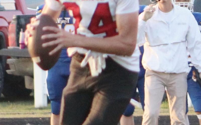 Beaverton used all of its weapons to bring home a 20-12 victory from Evart Friday night, including the passing of Jace Mishler (left) and the hits provided by Aidan Elkholy and the defense.