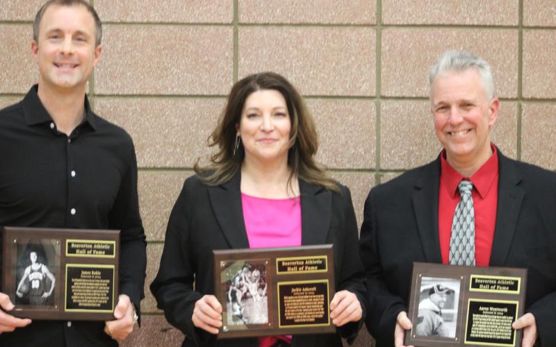 The latest inductees into the Beaverton Hall of Fame (left to right) James Ruhle, Jackie Wheeler and Aaron Wentworth pose with their plaques on Hall of Fame Night at the school’s gym.