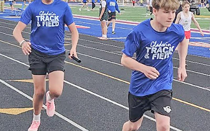 Bentley Grice and WiIliam Kruske accomplish a successful handoff in their relay.