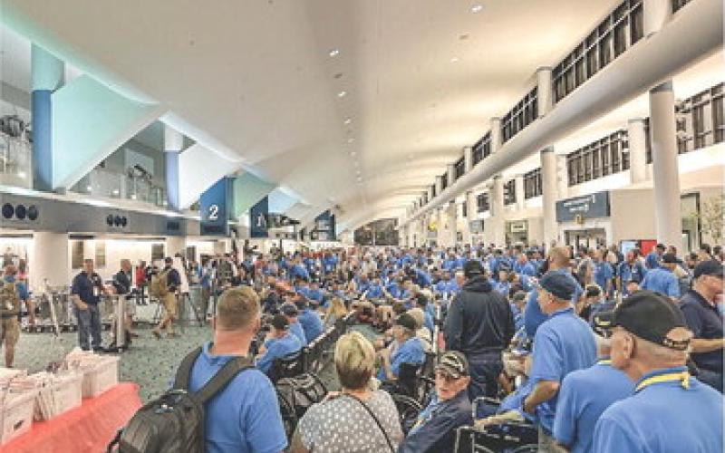 Veterans and their chaperones and families gathered in the main lobby of Bishop International Airport in Flint.