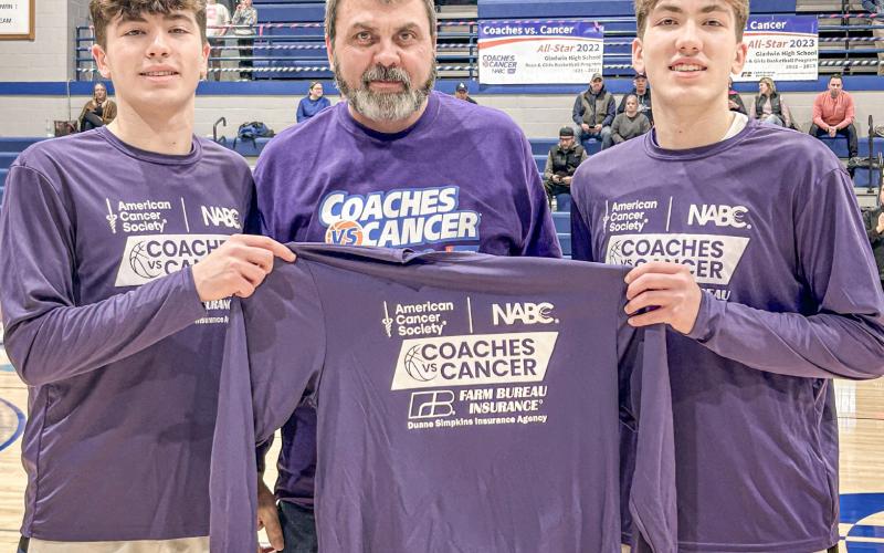 Farm Bureau Insurance Agent Duane Simpkins donated the commemorative jerseys worn by Gladwin’s basketball teams during the Coaches Vs. Cancer games last week and he was thanked pregame by Brody and Ben Verellen.