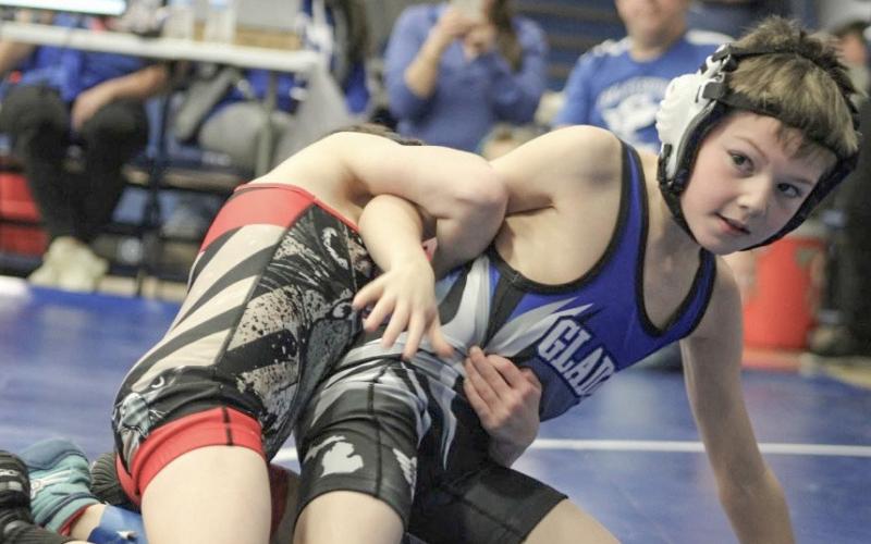 Pictured is Trevor Faber wrestling an opponent Feb. 1. Inset photo Cruz Hair.