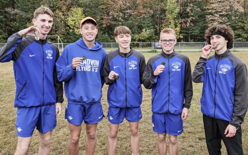 Gladwin’s (left to right) Elijah Christensen, Caleb Palmreuter, Ben Verellen, John Whitman and Myles Robinson enjoy an invitational victory at Meridian.