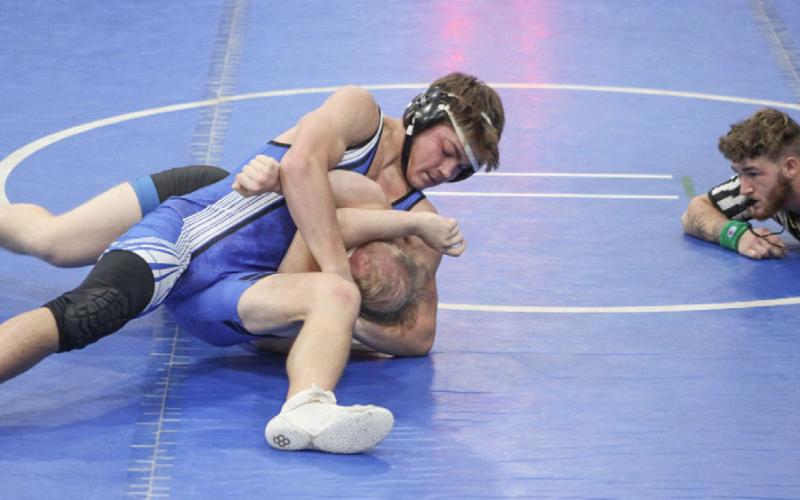 Gladwin’s Lorcan Keatley applies a headlock during a recent match. The Flying G’s swept a tri-meet at Evart to open the season last week.