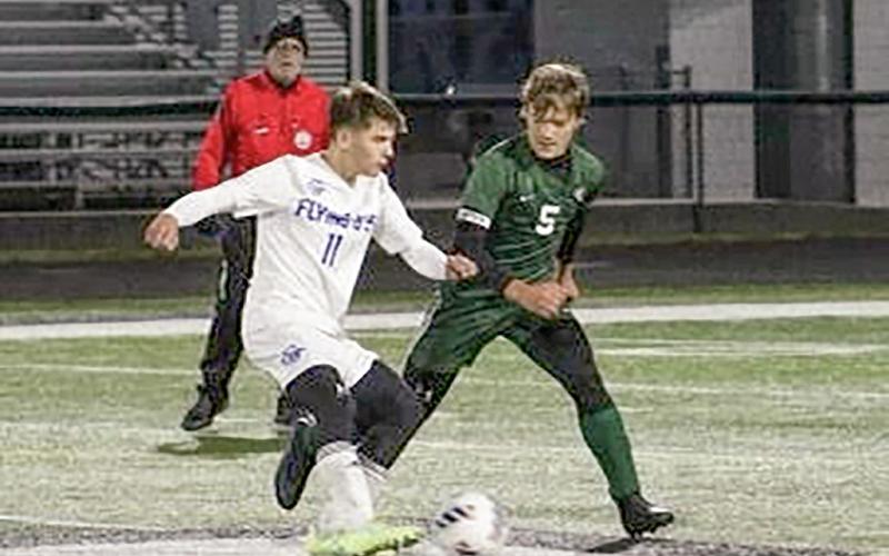 Gladwin’s Andrew Von Matt wards off a Clare defender during the Flying G’s 2-1 double overtime league championship victory.