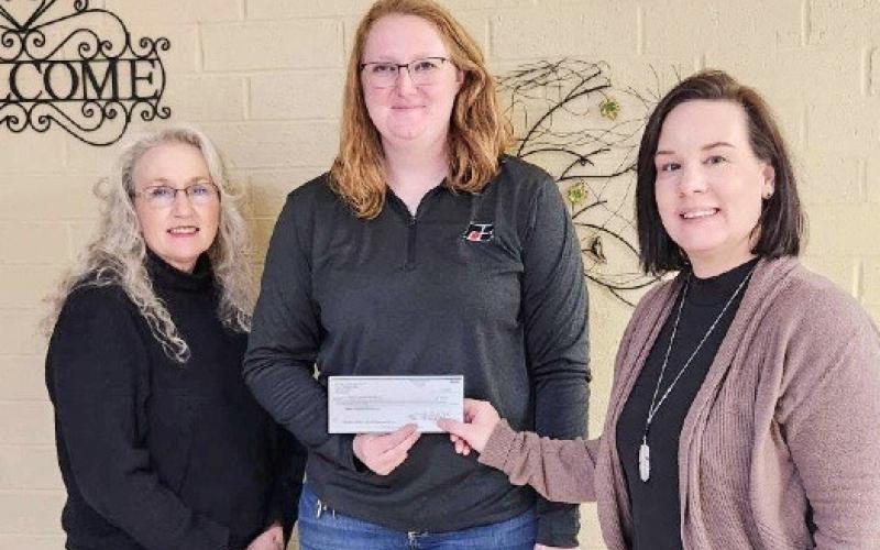 Sarah Hollon (center), Clare County Farm Bureau Young Farmer Co-Chair and golf scramble organizer presented the Gladwin Community Service Corp. – Council on Aging with a $620 donation.