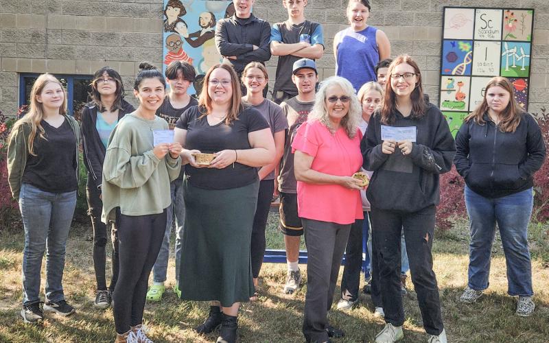 Pictured in front row, left to right: Advanced art students, Aubrey Fairchild and Harmony Albain; and Anna McNeil and Lori Stout from the Council on Aging. Second row, left to right: Aubrey Shanahan, Veronica Gower, Kempton Harvey, Charlotte Mawhorter, Isaac Friesen, Faith Hude, Wyatt Lier, and Brianna Vincent, Back row, left to right: Mason Heppner, Keegan Estes, and Emily Hough.