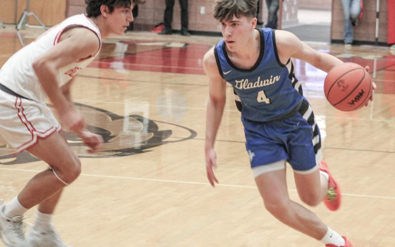 Gladwin’s Ben Verellen dribbles away from Beaverton’s Sean Barta during Gladwin’s victory in the Battle for Butch last week.
