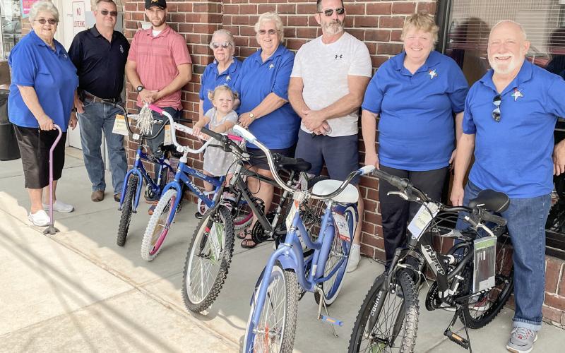 Eastern Stars and Masons donated five bikes to Harrison Public Library Kids Reading Program. Pictured left to right are: Donna Alessandri, Rob Nix, Shawn, Mary Marcum, Ester (on bike), Marilyn Walker, Randy Marlow, Val Kusiak, and Bill Bellairs.