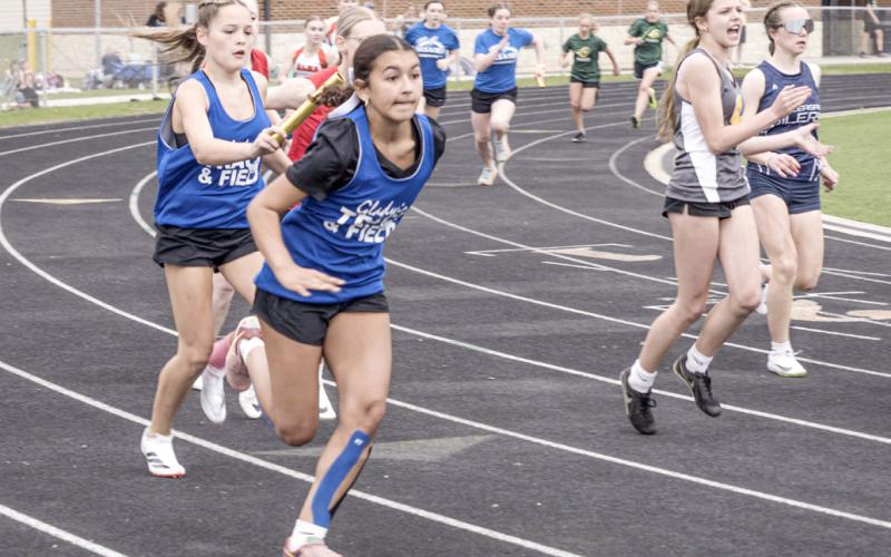 Elianna Celestino takes the handoff from Gladwin teammate Lily Hillier during a relay race at Friday’s meet at Alma.