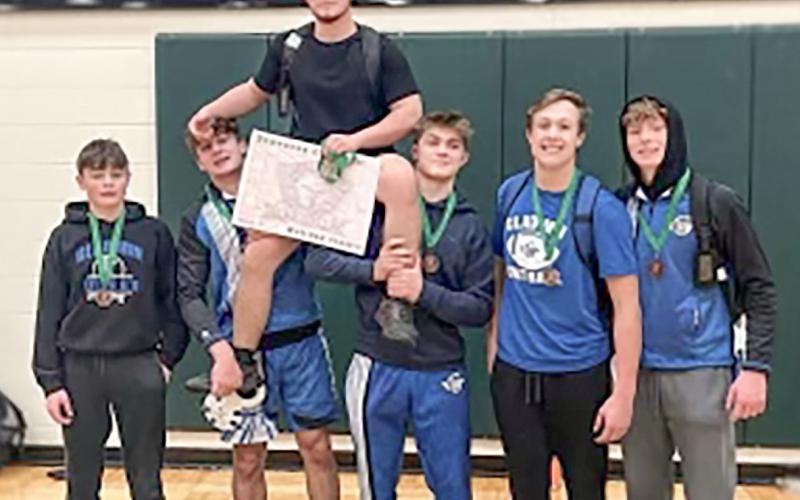 Gladwin’s (left to right) Braden Ritchie, Harvey Grove, Gaven Evans-Ferguson, Lorcan Keatley, Brady Demory, Ethan Palmateer and Drake Ross pose after winning medals at the Traverse City West Invitational Thursday.