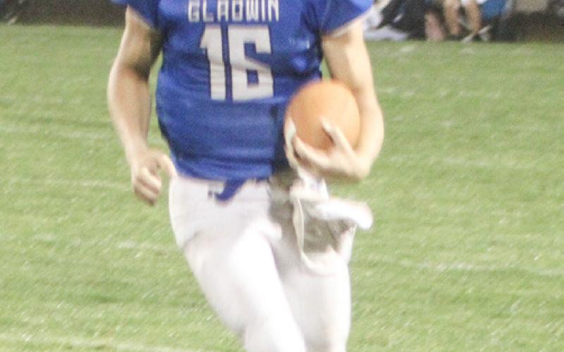 Colton Pfenninger runs for a touchdown in the fourth quarter of Gladwin’s loss to Clare Friday night.