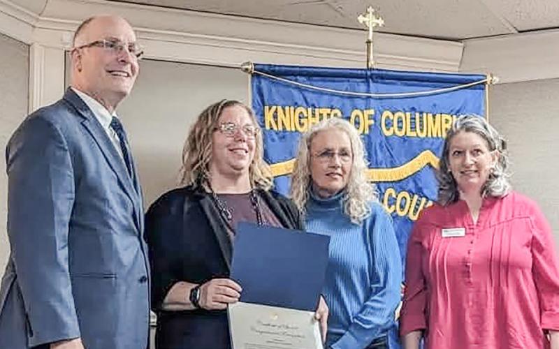 Prior to addressing the recent Gladwin County Chamber of Commerce Legislative Breakfast, Congressman John Moolenaar presented a Certificate of Special Congressional Recognition to Gladwin City-County Transit in honor of its 50th year of community service. At the podium are (left to right) Moolenaar, Transportation Director Kim Bruner, Executive Director Lori Stout and Chamber Director Carrie Will.