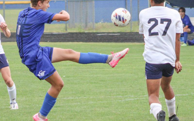 Gladwin’s Keaton Mausolf boots one out of the air during a recent game.