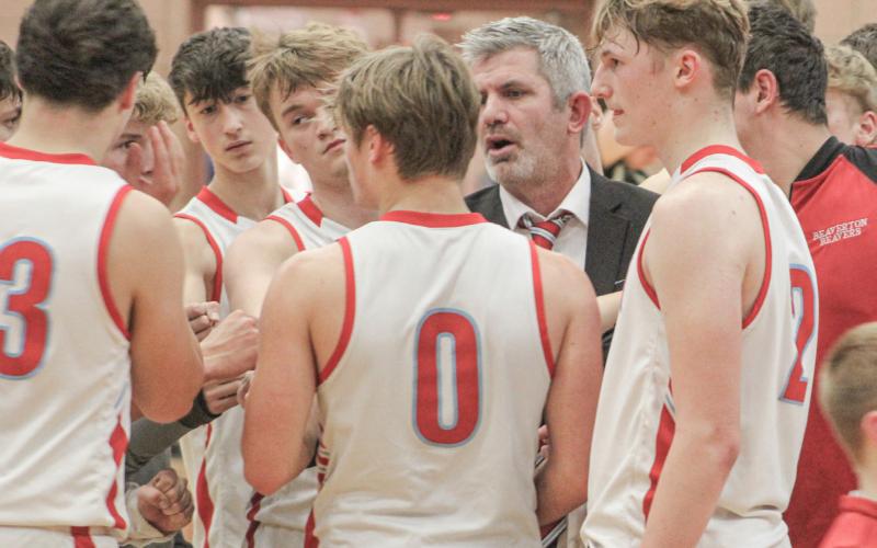Beaverton coach Shad Woodruff talks strategy with the troops during a timeout in the waning moments of Friday night’s loss to Bullock Creek.