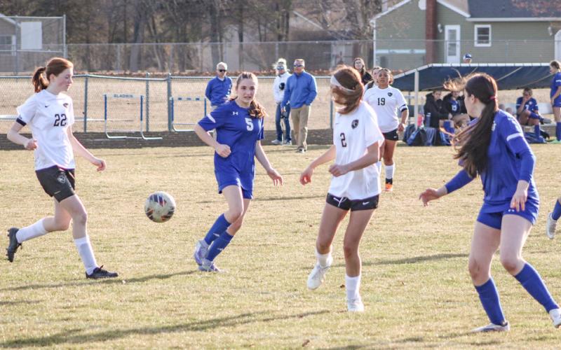 Gladwin’s Hallee LaBrosse draws a bead on the bouncing ball while surrounded by Bullock Creek defenders during Thursday’s victory.